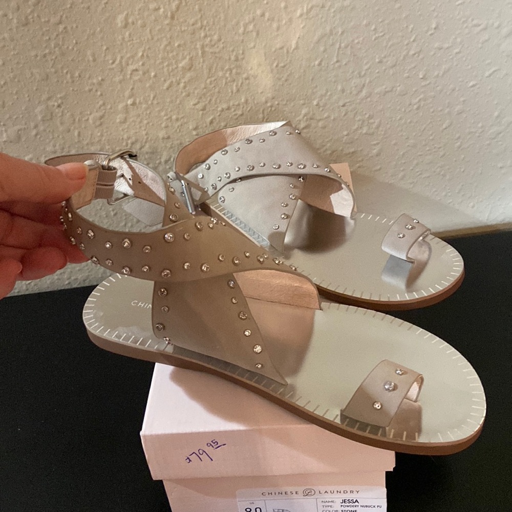 Sandals.  Wrap and buckle. Never worn. Stone. Kind of a tan.  With rhinestones